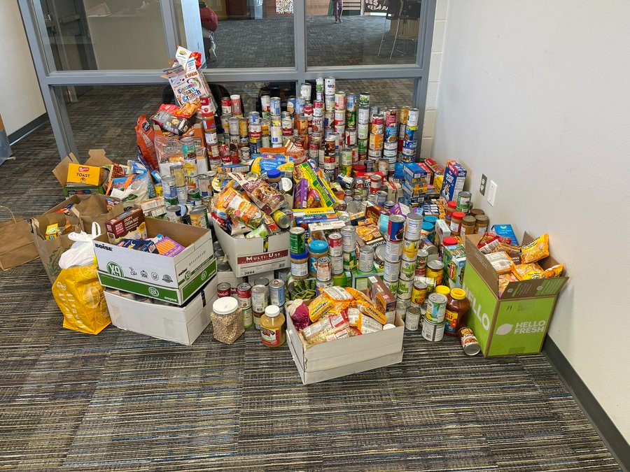 Stacks of donated food located on the floor of the main office of MRMS ready to be taken to the Care and Share of Colorado Springs